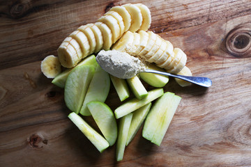 Cut banana and apple with some protein powder, ready for making a healthy shake.
