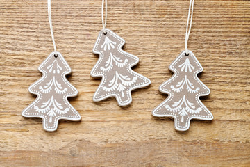 Christmas trees on rough wooden background.