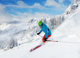 Fototapeta na wymiar Man skier running downhill