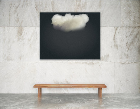 Black picture with white cloud on the wall above wooden bench on