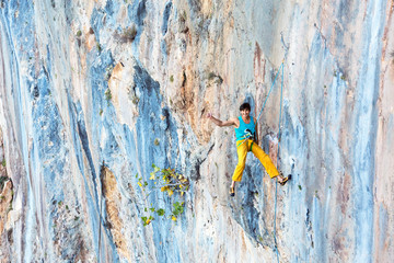 Fototapeta premium Smiling male Rock Climber descending on Rope with Okey hand sign