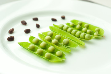 Green peas in beans on white plate