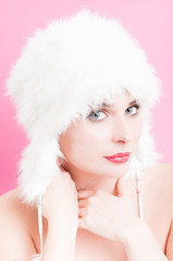 Handsome female with sexy look and white fur hat