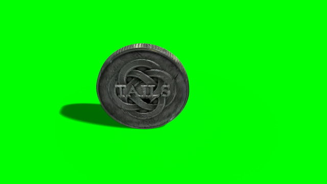 A worn antique silver coin with a heads and tails side spinning on a green screen background