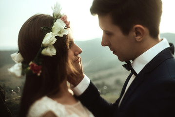 luxury happy bride and stylish groom hugging each other with ten