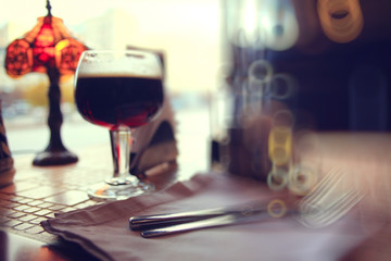 glass of dark beer in a pub