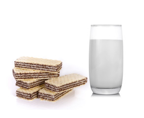 Glass of milk with waffles isolated on white background