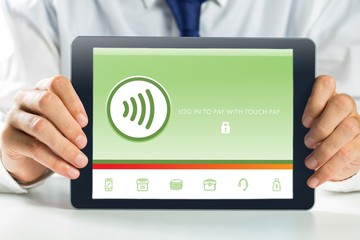 Composite image of businessman showing tablet pc