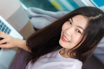 Happy smiling asian women browsing internet on laptop