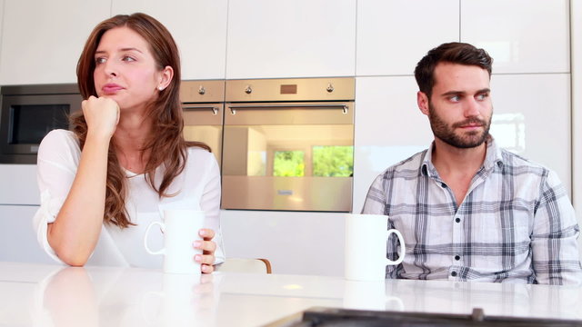 Couple not talking after an argument in kitchen