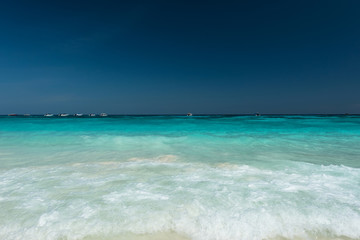 Fototapeta na wymiar Water splash and clear on beautiful beach ,Located at Ta Cai Island ,Thailand