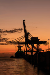 Fototapeta na wymiar Silhouette of container cargo and crane bridge