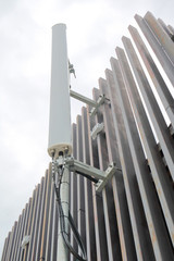 Dipole antenna for telecommunications contrasting white sky back