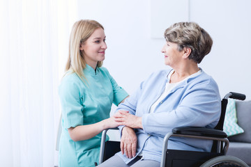 Nurse caring about elder woman