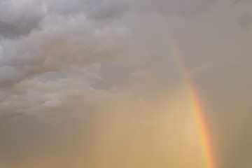 colorful rainbow on rain cloud sunset sky