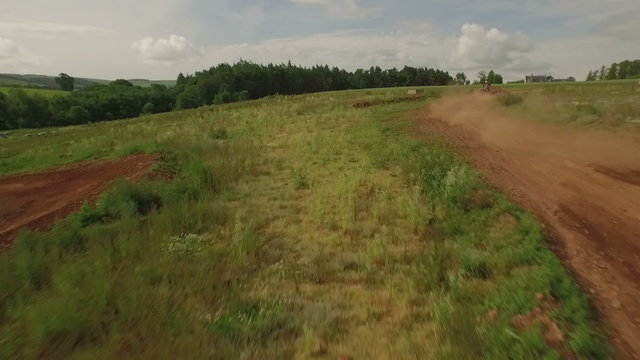 Tracking drone shot of quad bikes / off road vehicle on a dusty dirt track  
