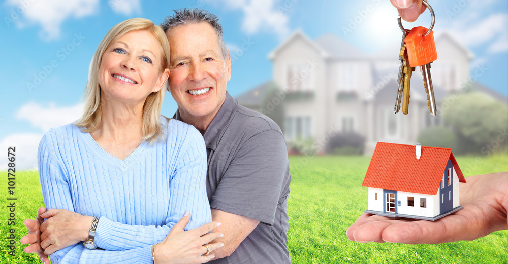 Canvas Prints Happy senior couple near family house.