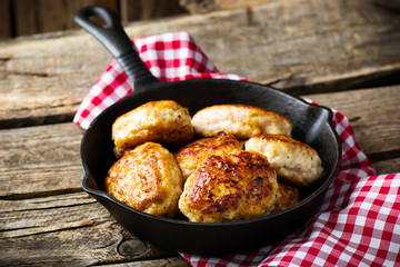 chicken cutlets on frying pan.