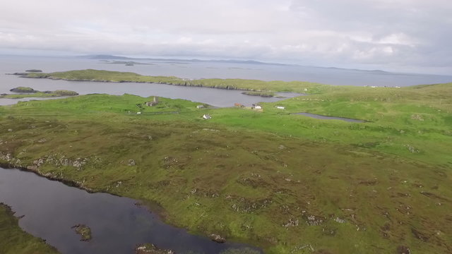Stunning aerial shot on the Isle of Harris, Scotland near the coast showing water and land
