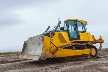 Obraz na płótnie Canvas Yellow bulldozer overcome barrier