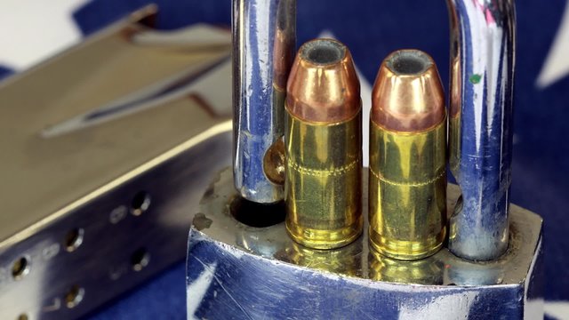 Ammunition and padlock on United States flag - Gun rights and gun control concept
