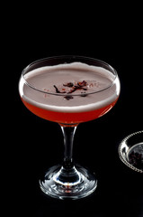 red cocktail with foam  and roses petal 