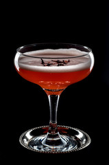 red cocktail with foam  and roses petal 