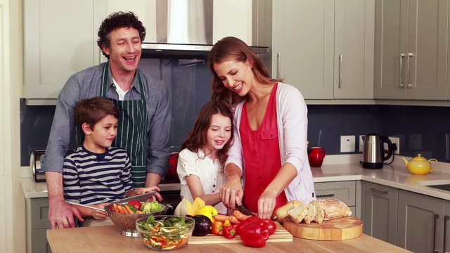 Happy family preparing vegetables together