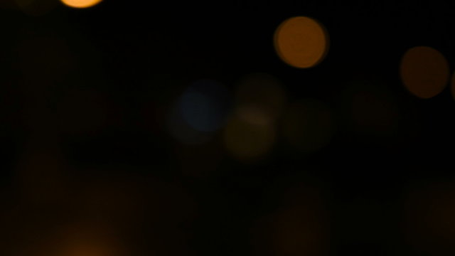 Handheld shot of defocused lights city night traffic