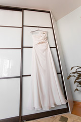 wedding dress hanging  at the room