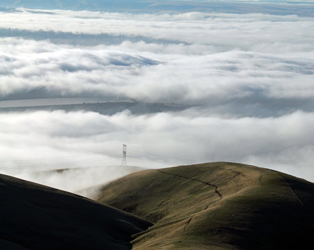 Clouds Covering a Mountain Valley with Rolling Hills