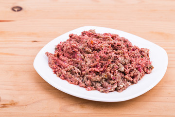 Fresh and nutritious minced raw meat dog food on plate