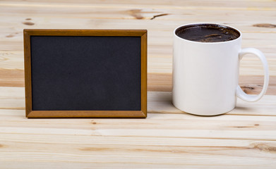 Big Cup Of Coffee With Blank Blackboard On Wooden Boards