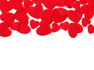 Red felt hearts on a white background. Valentine's Day and wedding background.