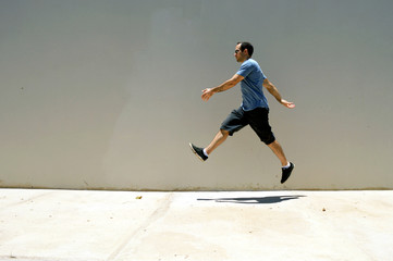 Fototapeta na wymiar Man air walking in front of a wall 