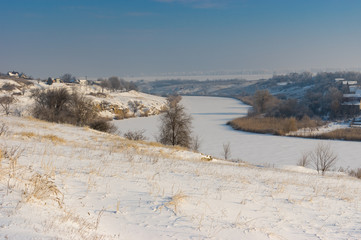 Winter landscape with Small river Sura flowing through Novo-Nikolaevka village in Dnepropetrovskaya oblast, Ukraine