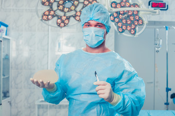 Surgeon at operating room in the hospital. breast augmentation