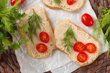 Breakfast sandwich with homemade paste, tomatos and greens
