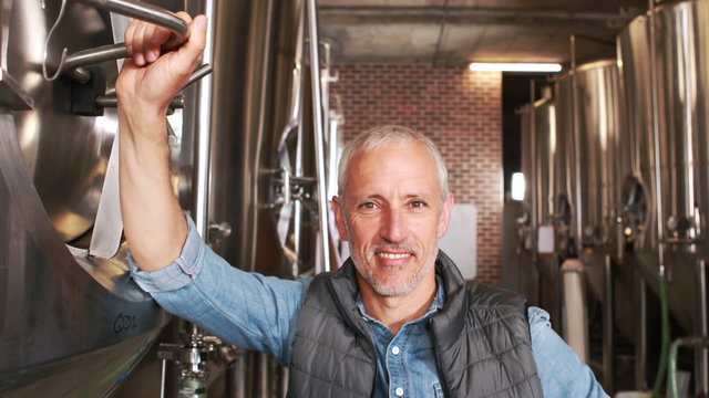 Brewery worker standing with thumbs up