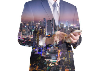 Double exposure of business man hand hold and touch screen smart phone, mobile and night city