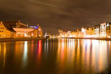 Fototapeta na wymiar Cityscape of Gdansk over the Motlawa river by night, Poland.
