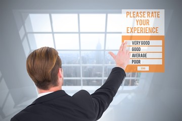 Rear view of businessman pointing with his fingers against room with large window showing city
