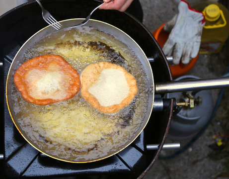 pancakes cooked in hot oil in pan aluminum