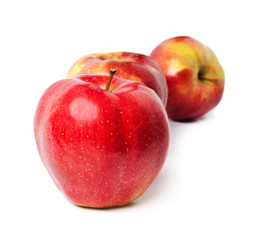 Fototapeta na wymiar three red apples stand in one row on a white background