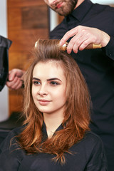 drying, styling women's hair in a beauty salon