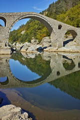 Fototapeta premium Amazing Reflection of Devil's Bridge in Arda river, Kardzhali Region, Bulgaria