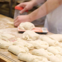 Chefs forming dough in order to prepare bread