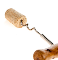 corkscrew screwed in to the wine cork on a white