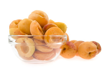 apricots lie a half in a dish on a background a heap apricot