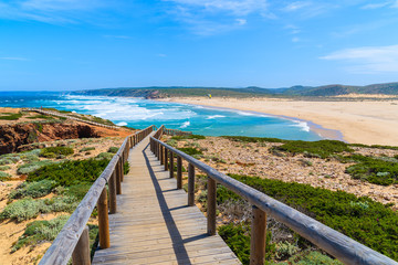Wooden walkway to Praia do Bordeira beach and beautiful blue sea view, Algarve region, Portugal